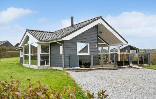 a gray house with a large front yard at Cozy Home In Lemvig With Sauna in Lemvig