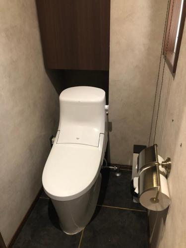 a bathroom with a white toilet in a stall at Hotel Nagasaki Station in Nagasaki