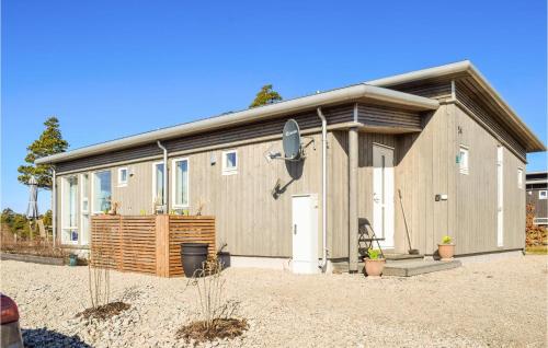 a large house with a garage at Nice Home In Manstad With Kitchen in Saltnes