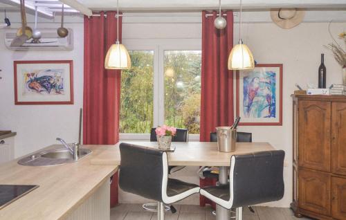 une cuisine avec une table et des chaises ainsi qu'une fenêtre dans l'établissement Beautiful Home In St Julien De Peyrolas, à Saint-Julien-de-Peyrolas
