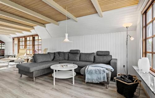 a living room with a couch and a table at 3 Bedroom Stunning Home In Farsø in Farsø