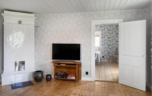a living room with a flat screen tv on a wall at 4 Bedroom Beautiful Home In Mönsterås in Mönsterås