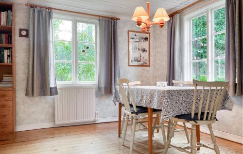 a dining room with a table and chairs at 3 Bedroom Lovely Home In Högsby in Högsby