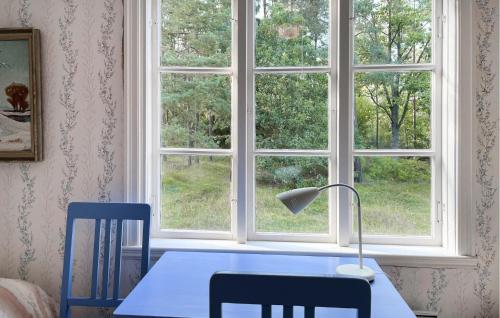a table and two chairs and a window at 3 Bedroom Lovely Home In Högsby in Högsby