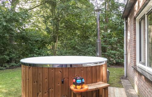 a jacuzzi tub in the backyard of a house at Nice Home In Hoeven With Sauna in Hoeven