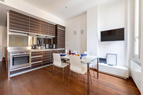 a kitchen with a table and chairs in a room at Brera Studio in the heart of Milan in Milan