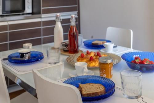 a table with blue plates of bread and fruit on it at Brera Studio in the heart of Milan in Milan