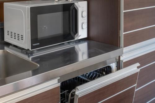 a microwave oven sitting on top of a kitchen counter at Brera Studio in the heart of Milan in Milan