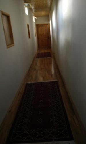 a hallway with a rug on the floor of a room at Hargisa Hut in Skardu