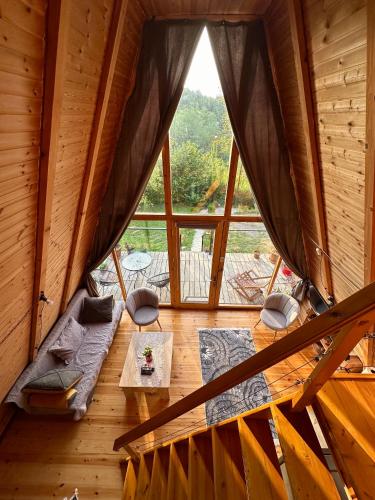 a room with a large window in a log cabin at Cottage Sataplia in Kutaisi