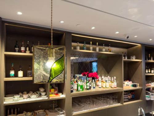 a bar with a light hanging from the ceiling at Yuexiu Hotel Guangzhou,Curio Collection by Hilton-Free shuttle between hotel and Exhibition Center during Canton Fair & Exhibitor Registration Counter in Guangzhou