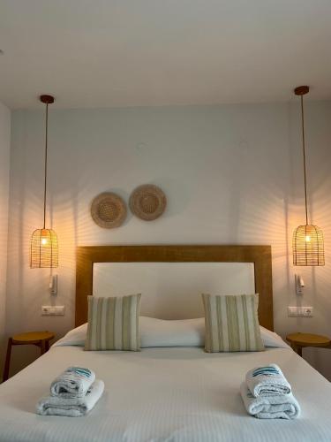 a bedroom with a bed with towels on it at Maritime Suites in Hersonissos