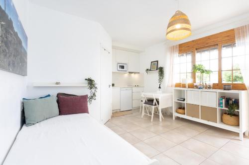 a living room with a bed and a kitchen at Bungalow Palm Mar with pool and garden in Arona