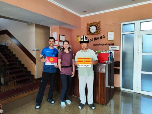 a group of three people standing in a lobby at Tagaytay Karakol Hotel in Karakol