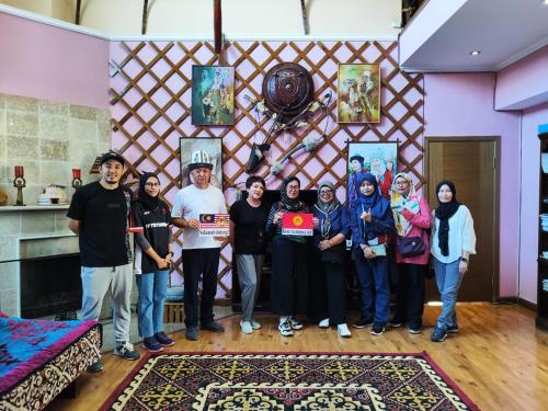 a group of people posing for a picture in a room at Tagaytay Karakol Hotel in Karakol