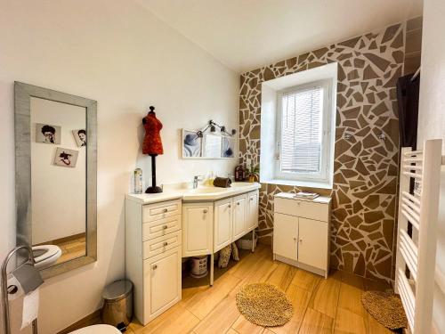 a bathroom with a sink and a mirror at Welcome to Tuffe in Tuffé