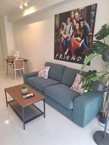 a living room with a blue couch and a table at 9 keys boutique apartments in Orestiada