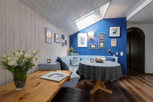 a dining room with a table and a blue wall at Le Mirabeau Resort & Spa in Zermatt