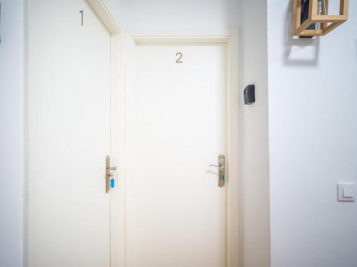 a pair of white doors in a room at Texeda Room Suites in Tejeda