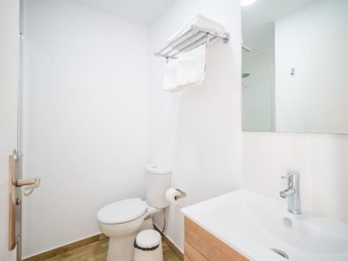 a bathroom with a toilet and a sink and a mirror at Texeda Room Suites in Tejeda