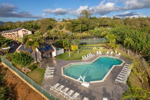 an aerial view of a swimming pool with lounge chairs and a swimming pool at Banyan Harbor Resort in Lihue