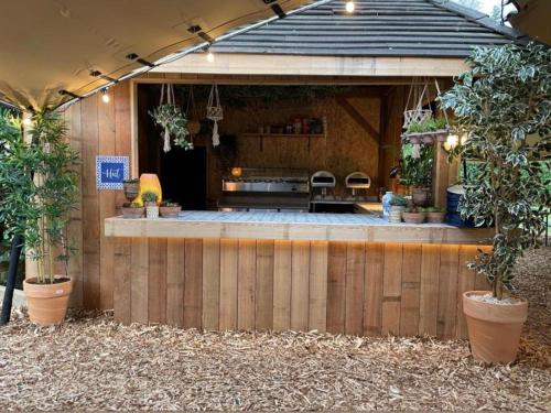 an outdoor bar with plants in a building at The Admirals Inn Guest House in Bracknell