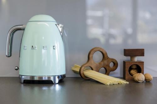a food processor sitting on a counter next to some pasta at Haus Wiesenstein in Lana