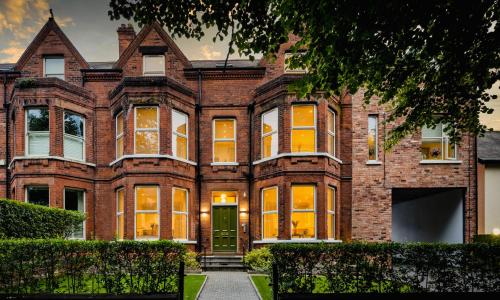 a large brick building with a green door at 5 Star - The Ulsterville Residences - Free On-site Parking in Belfast