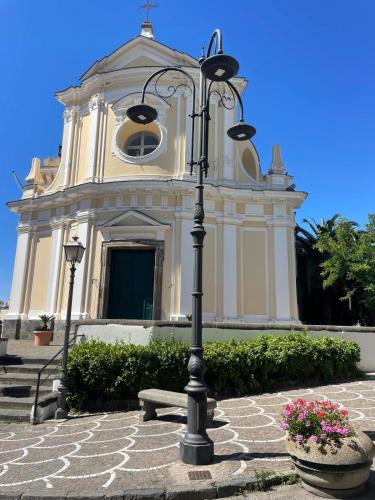a church with a street light in front of a building at Ammore Ammare Apartment in Ischia