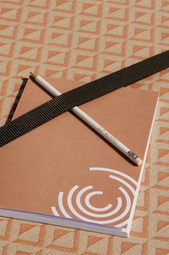 a pencil sitting on top of a paper at Sun Aeriko in Tinos Town