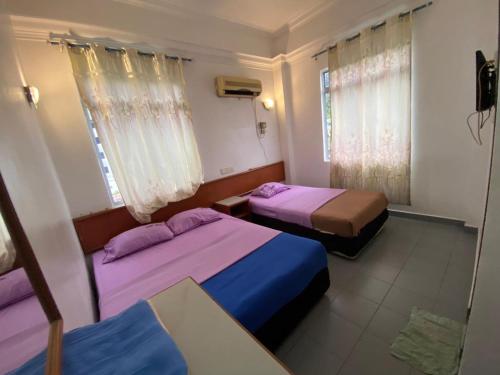 Postel nebo postele na pokoji v ubytování Dung Fang Hotel