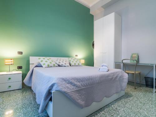 a blue bedroom with a bed and a desk at Homeboutique in Cagliari