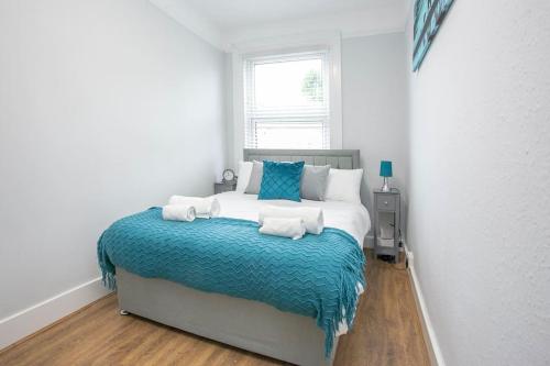 a bedroom with a large bed with towels on it at Large Stylish 2bedroom flat in Wood Green in London