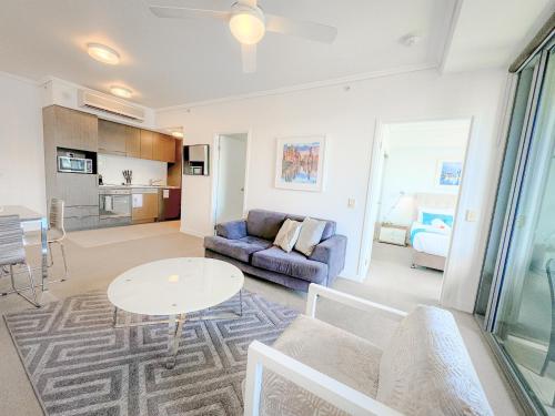 a living room with a couch and a table at Apartments on Connor in Brisbane