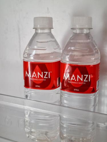 two bottles of coca cola in a refrigerator at Winterton Country Lodge @ Rose Cottage in Winterton