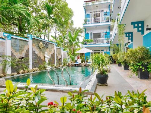 a swimming pool in the middle of a building at Lucky Leaf Hoian Villa in Hoi An
