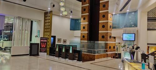 a lobby of a building with a wall of wood at Inn Riviera Jammu in Jammu
