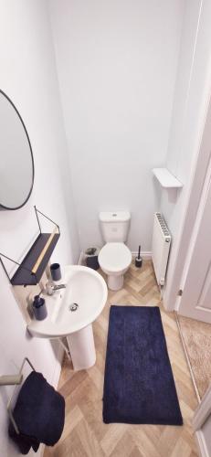 a bathroom with a toilet and a table and a mirror at The willow tree inn in Pilsley