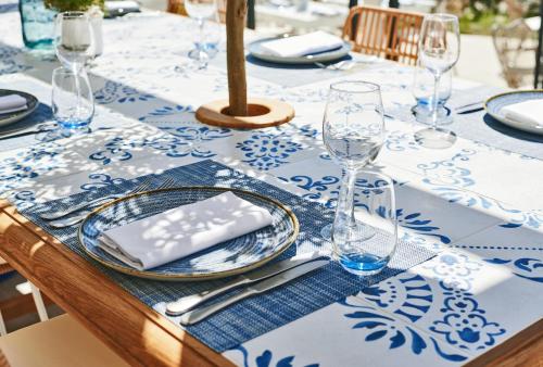 a table with a blue and white table cloth with glasses at Ikos Andalusia in Estepona