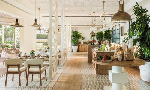 a dining room with a table and some plants at Ikos Andalusia in Estepona