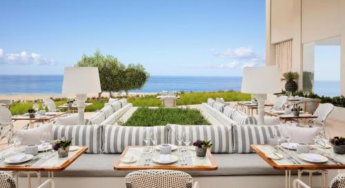 a restaurant with a view of the ocean at Ikos Andalusia in Estepona