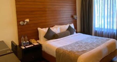 a hotel room with a bed and a window at The Golkonda Resort and Spa in Hyderabad