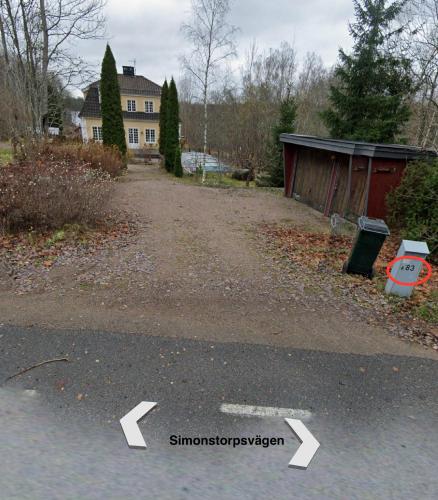 a driveway in front of a house with a street at Hasselbacken in Rejmyre