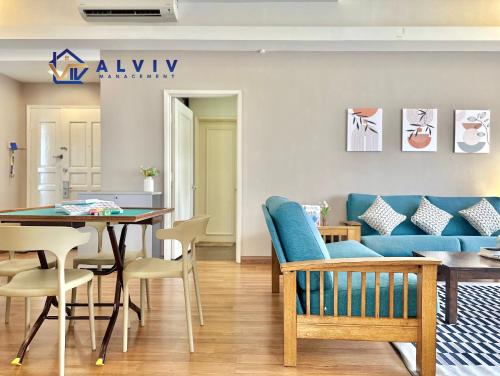 a living room with a blue couch and a table at Costa Mahkota - 1min I Mahkota Parade Mall I Dataran Pahlawan I Mahkota Hospital in Melaka
