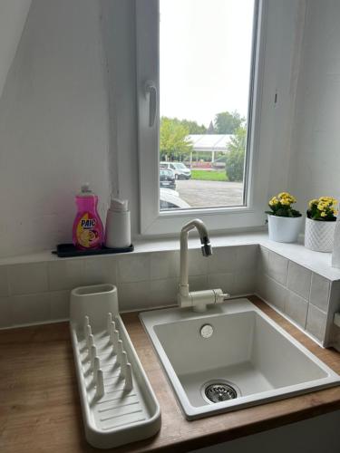 a kitchen counter with a sink and a window at La petite maison d'Arbas in Arbas