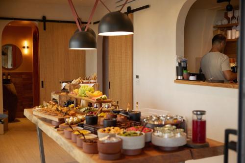 a buffet of food on a table in a room at Sun Aeriko in Tinos Town