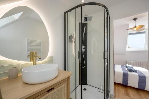 a bathroom with a sink and a shower at Ty Mémène - Magnifique bâtisse bretonne in Plérin