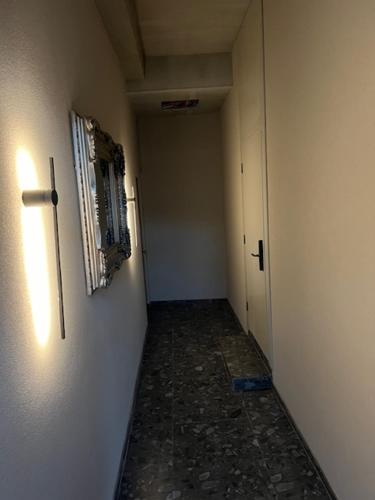 a corridor of a hallway with a door and a room with a wall at Old Town - Bajor Studios 2 - Self Check-in and Parking in Kaunas