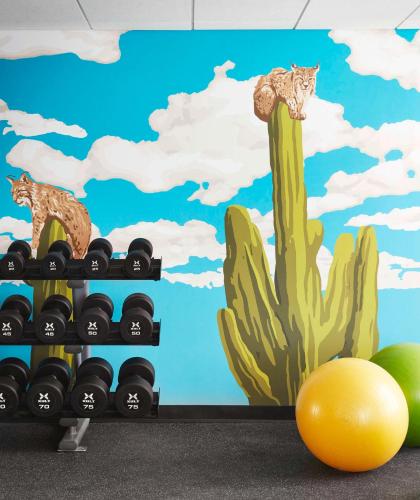a wall mural with cats on a cactus at Graduate by Hilton Tucson in Tucson