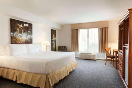 a hotel room with a bed and a large window at Days Inn by Wyndham Niagara Falls Centre St By the Falls in Niagara Falls